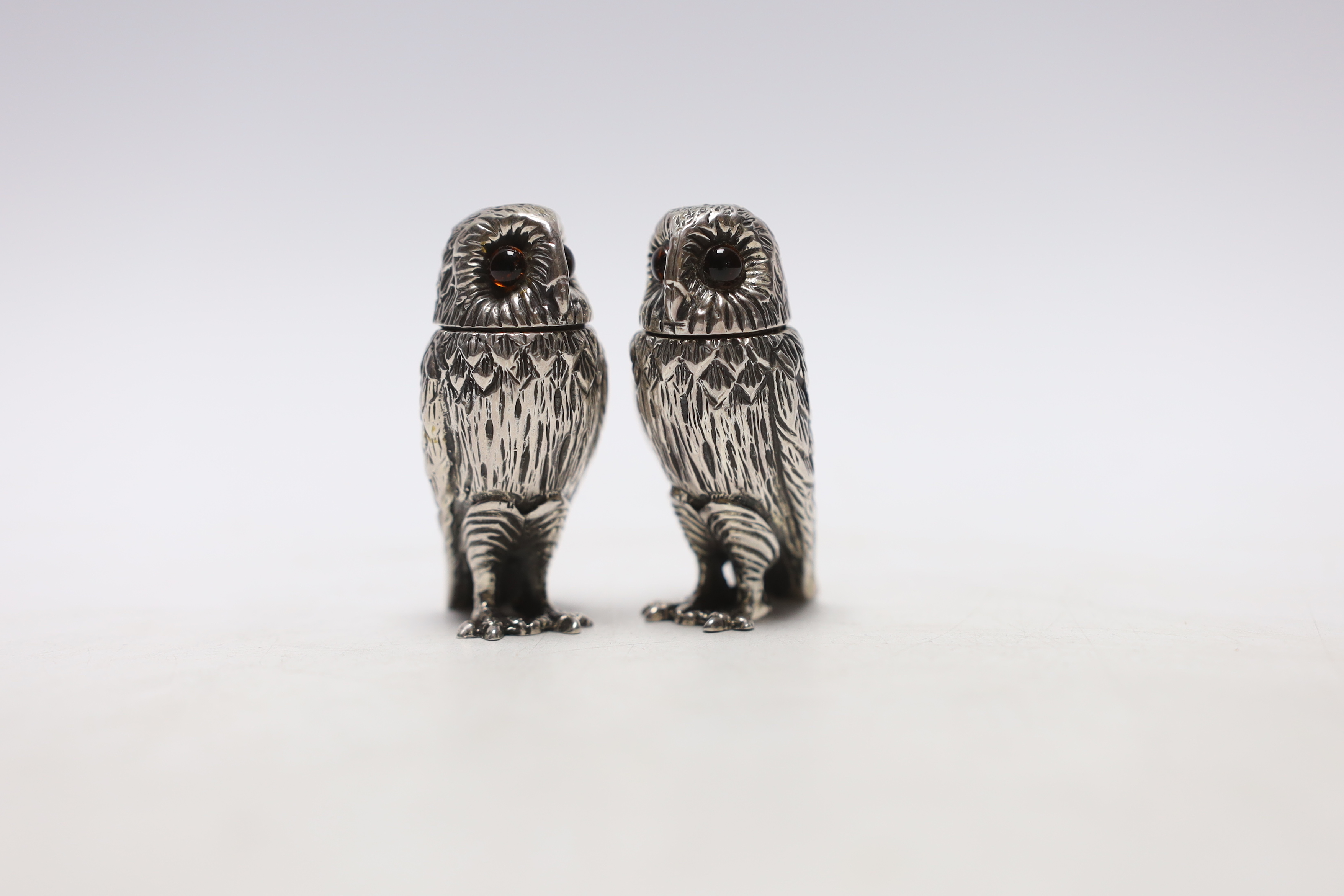 A pair of Elizabeth II novelty silver condiments, each modelled as an owl, maker WW, London, 2008, 51mm.